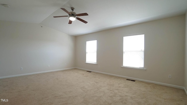 unfurnished room with light carpet, baseboards, visible vents, and ceiling fan