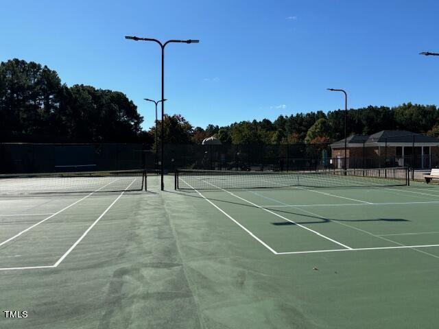 view of tennis court with fence