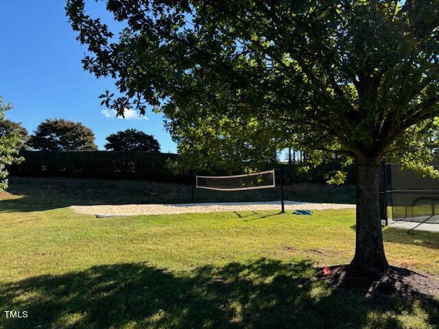 surrounding community featuring volleyball court and a yard