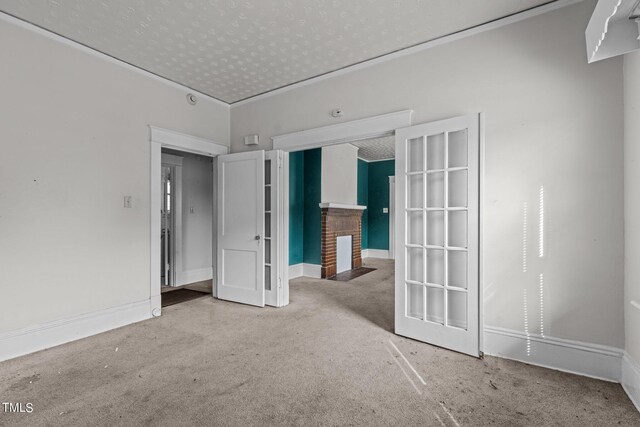 810 E Edenton St, Raleigh, NC 27601 - carpeted spare room featuring a brick fireplace and baseboards