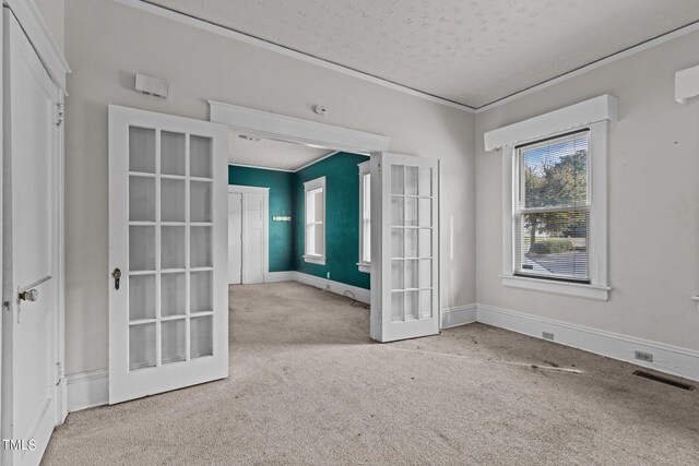 810 E Edenton St, Raleigh, NC 27601 - unfurnished room with french doors, carpet flooring, and a textured ceiling