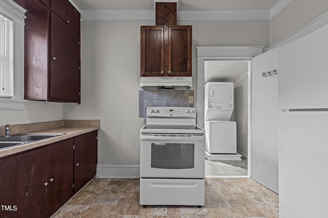 810 E Edenton St, Raleigh, NC 27601 - kitchen with white range with electric cooktop, stacked washer and clothes dryer, under cabinet range hood, stone finish floors, and ornamental molding