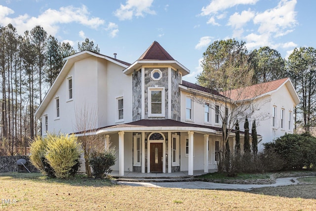 view of front of house with a porch and a front lawn