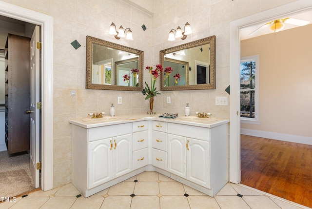 bathroom featuring tile patterned flooring, vanity, and tile walls