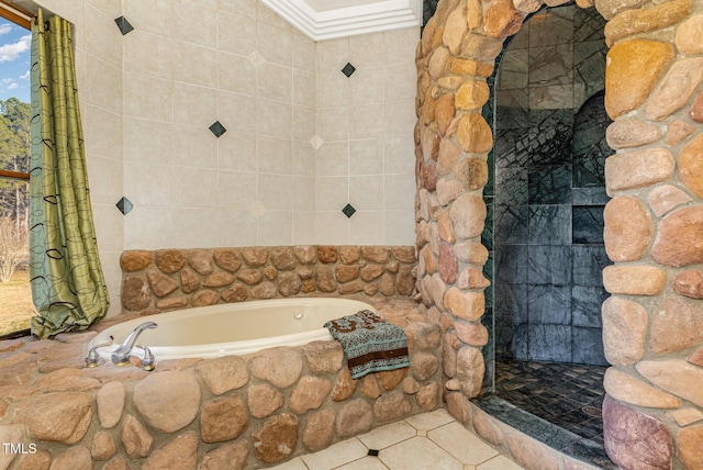 bathroom with tile patterned flooring, a relaxing tiled tub, and crown molding