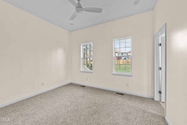 carpeted spare room with ceiling fan