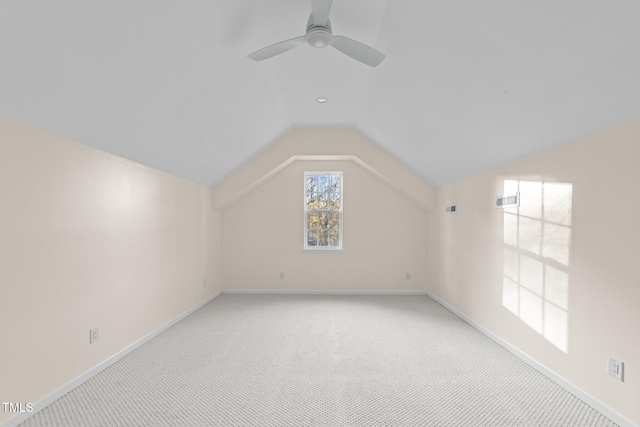 additional living space with ceiling fan, light carpet, and vaulted ceiling