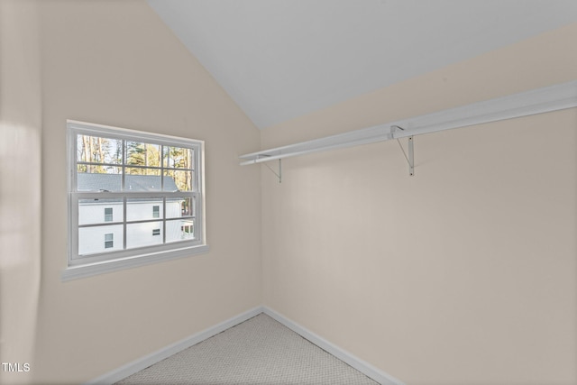 spacious closet with carpet flooring and vaulted ceiling