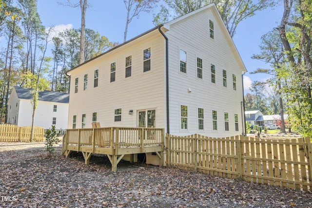 back of property featuring a wooden deck