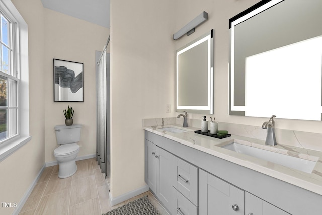 bathroom featuring tile patterned floors, vanity, and toilet