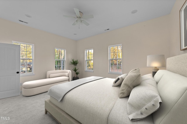 bedroom with light colored carpet and ceiling fan