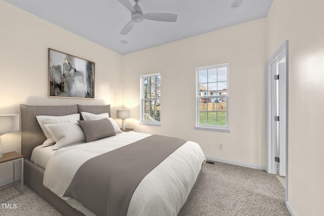 bedroom with ceiling fan and light carpet