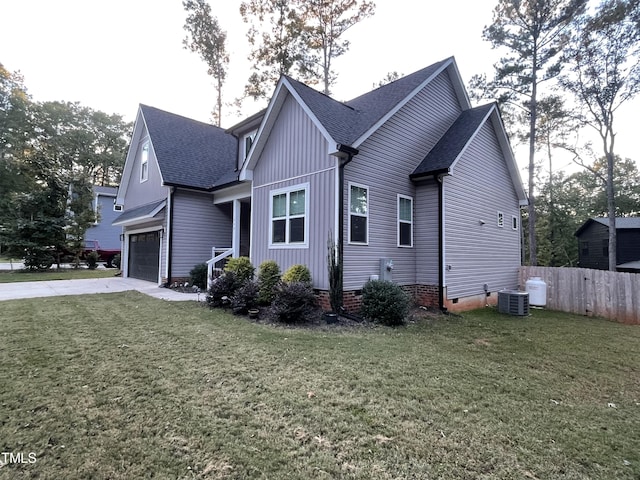 view of side of home with central AC and a lawn