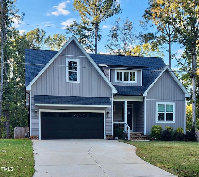 view of front of property featuring a front lawn and a garage