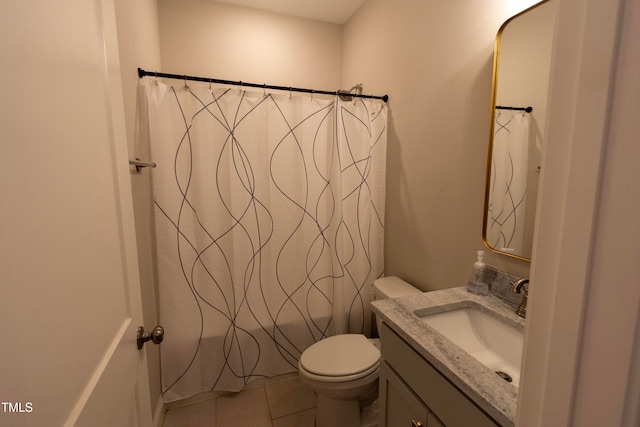 bathroom with vanity, toilet, and tile patterned floors