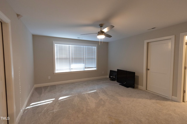 empty room with ceiling fan and light colored carpet