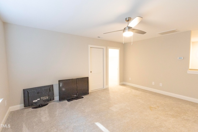 empty room featuring light carpet and ceiling fan