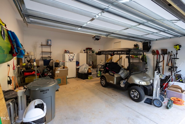 garage featuring a garage door opener and white fridge