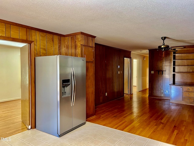 kitchen with stainless steel refrigerator with ice dispenser, a textured ceiling, light wood-type flooring, and ceiling fan