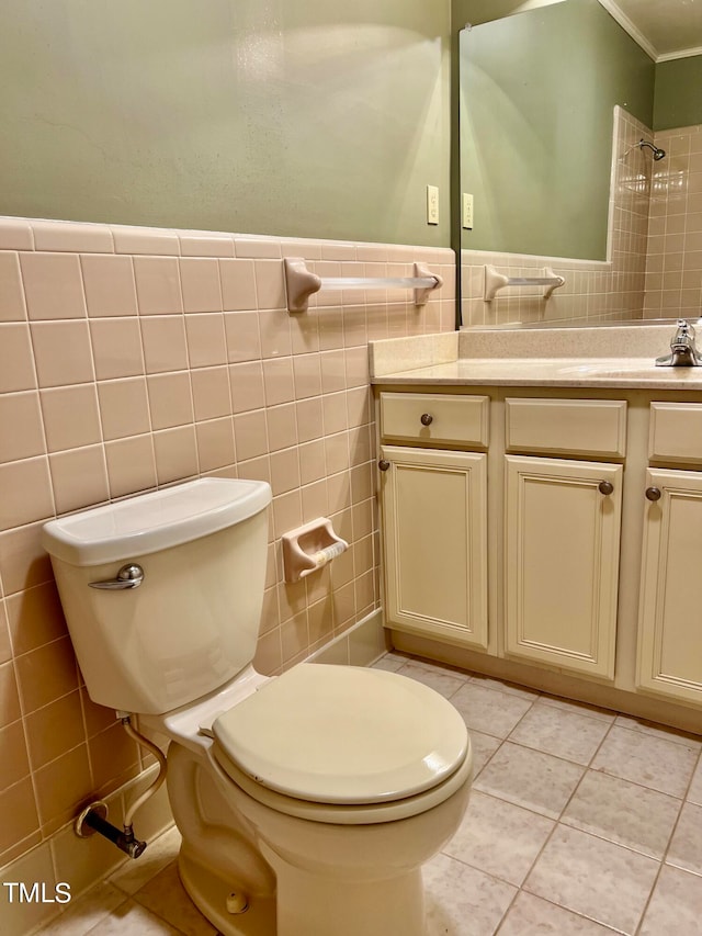 bathroom featuring tile walls, vanity, toilet, and tile patterned flooring