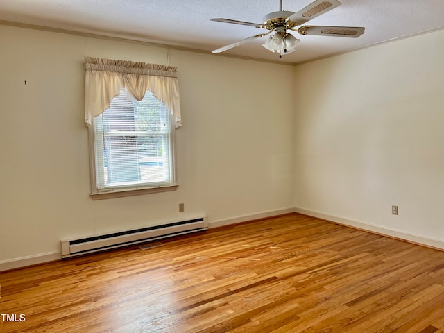 spare room featuring a baseboard radiator, a textured ceiling, light wood-type flooring, and ceiling fan