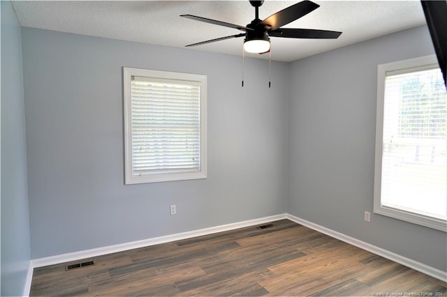 spare room featuring ceiling fan, a textured ceiling, and dark hardwood / wood-style flooring