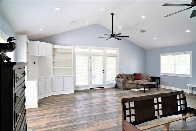 living room featuring ceiling fan, dark hardwood / wood-style floors, and high vaulted ceiling