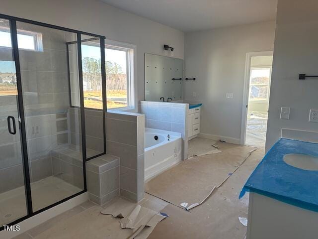 bathroom featuring independent shower and bath and vanity