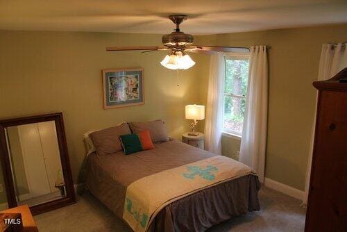 bedroom with light carpet and ceiling fan