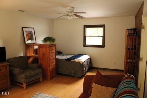 bedroom featuring light wood-type flooring and ceiling fan