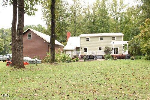 rear view of house with a yard