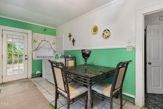 dining area featuring crown molding and light tile patterned floors