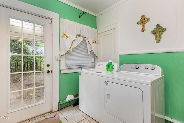 washroom featuring laundry area, crown molding, light tile patterned floors, and washing machine and clothes dryer