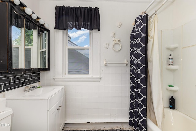 full bath with toilet, plenty of natural light, and vanity