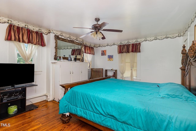 bedroom with ceiling fan and wood finished floors