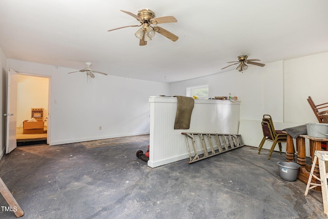 living area featuring concrete flooring and ceiling fan