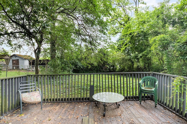 deck featuring a lawn and fence