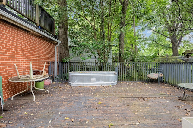 view of patio featuring a wooden deck and fence