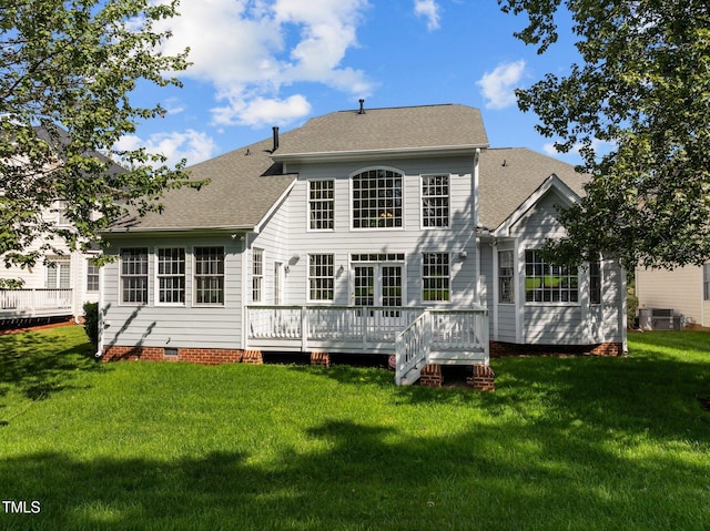 rear view of property featuring a yard and a deck