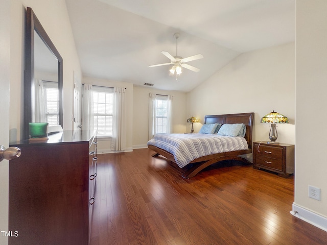 bedroom with dark hardwood / wood-style flooring, ceiling fan, and vaulted ceiling