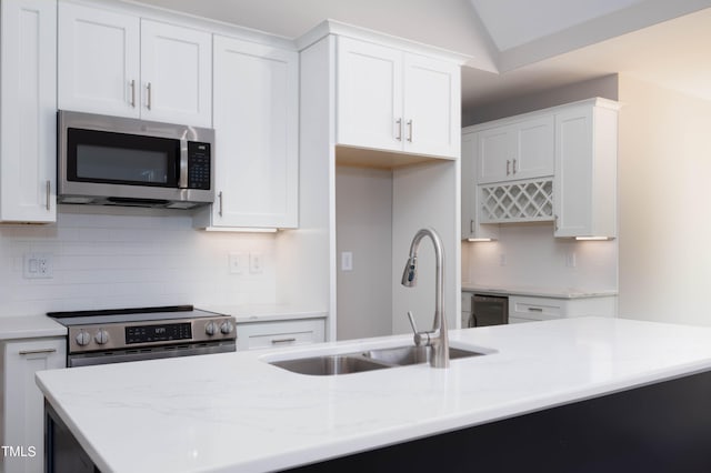 kitchen with sink, appliances with stainless steel finishes, and white cabinetry