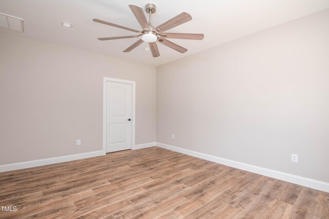 empty room with ceiling fan and wood-type flooring