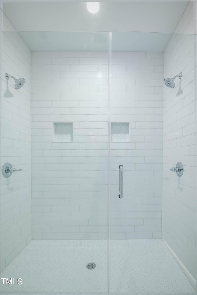 bathroom featuring a shower with shower door