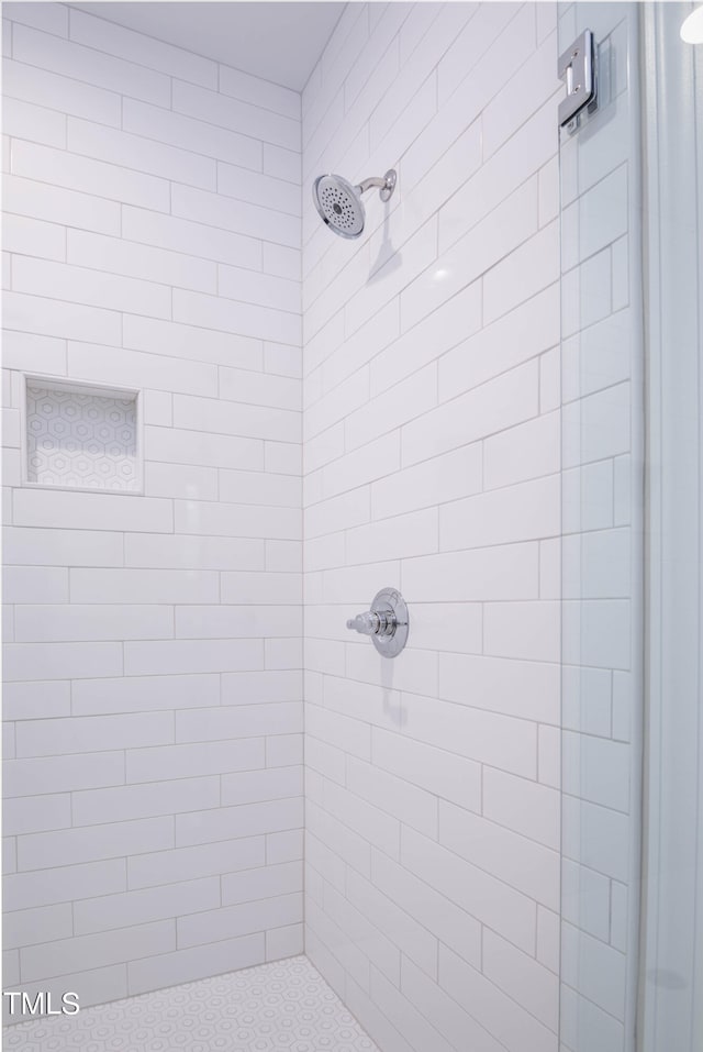 bathroom with tiled shower