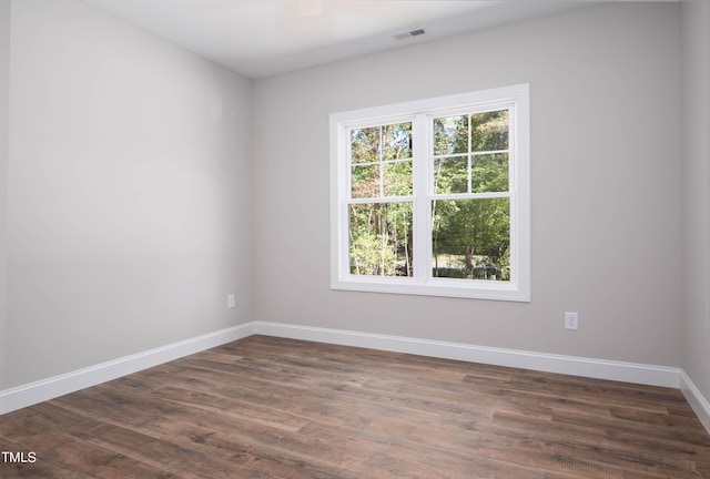 unfurnished room featuring dark wood-type flooring