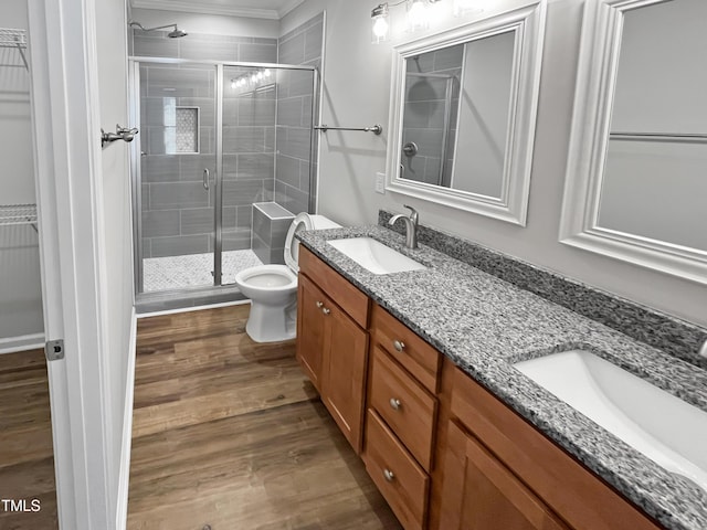 1505 Juniper St, Durham, NC 27703 - bathroom featuring a shower stall, wood finished floors, double vanity, ornamental molding, and toilet