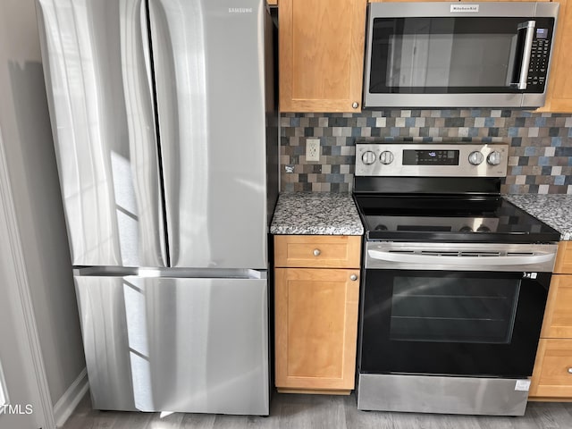 1505 Juniper St, Durham, NC 27703 - kitchen featuring stainless steel appliances, tasteful backsplash, and light stone countertops