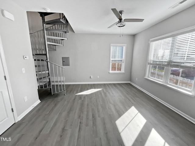 1505 Juniper St, Durham, NC 27703 - unfurnished living room featuring a ceiling fan, stairs, wood finished floors, and baseboards