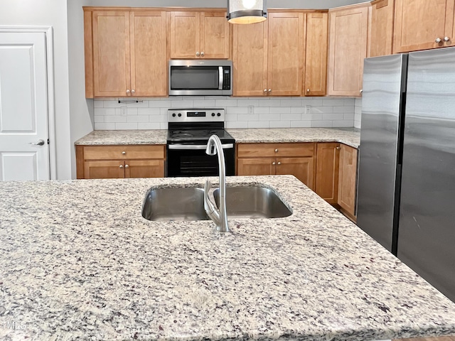 1505 Juniper St, Durham, NC 27703 - kitchen with stainless steel appliances, a sink, backsplash, and light stone counters
