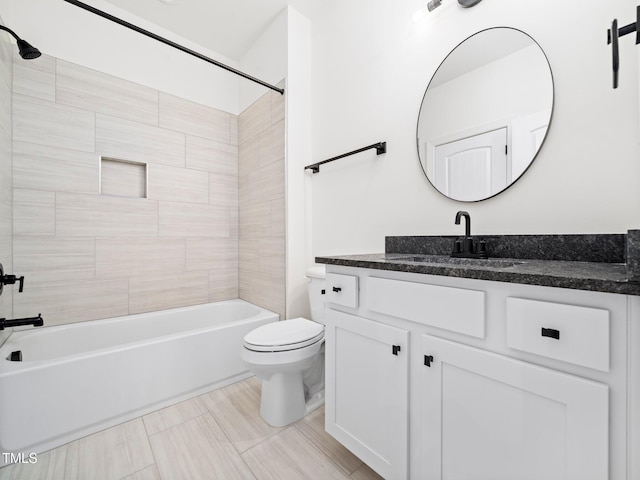 full bathroom with vanity, toilet, and tiled shower / bath